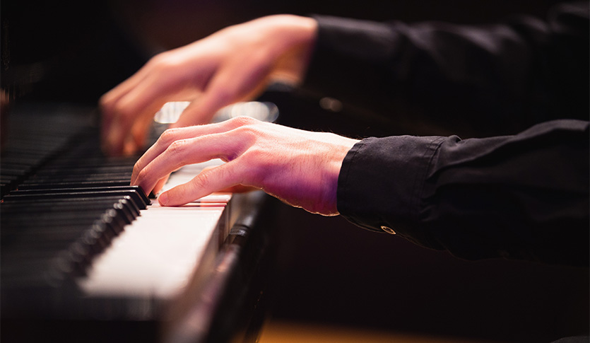 A picture of a piano being played
